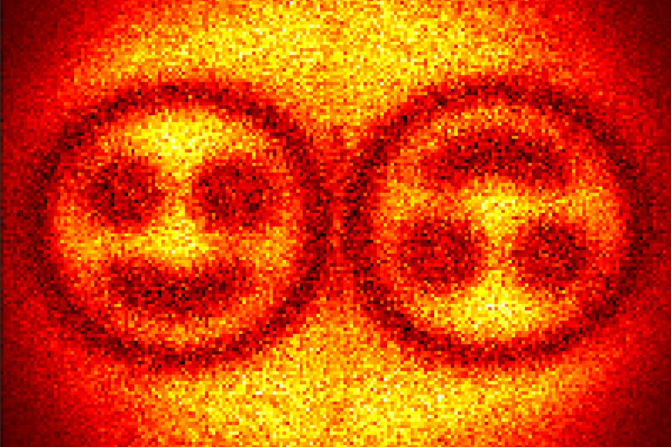 Two images of a smiling face, one upside down.