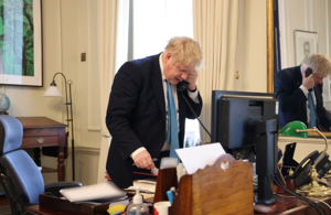 Boris Johnson stands at his desk on the phone to President Volodymyr Zelenskyy of Ukraine.