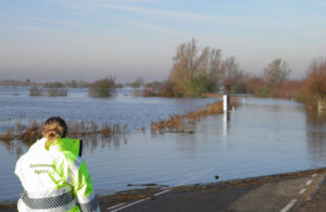 An Environment Agency official checks flood waters