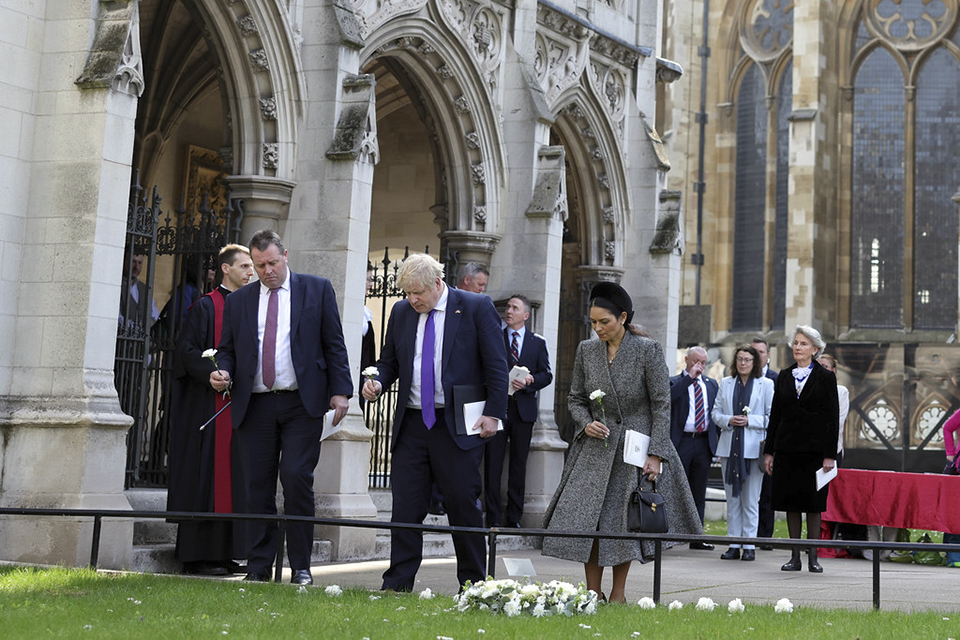  Boris Johnson accompanied by the Priti Patel and Mark Spencer lay a white rose after the service at St Margaret’s church