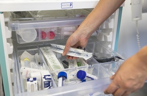 Doctor removing medical supplies from a drawer