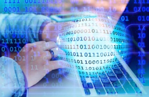 Woman sitting at computer with overlay of digital coding