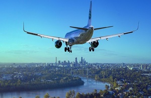 Airplane flying over city and preparing to land
