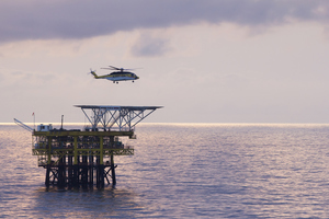 An offshore helicopter transporting workers to oil rigs