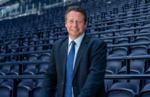 Sports Minister in suit and tie stands in Tottenham Hotspur safe standing facility