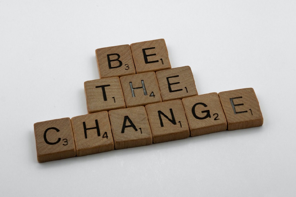 Wooden letter tiles spelling 'be the change'
