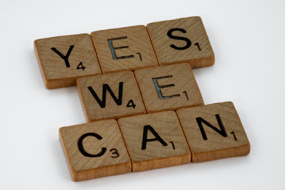 Wooden letter tiles spelling 'yes we can'