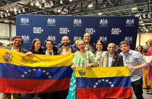 A group of successful candidates with the Venezuelan flag