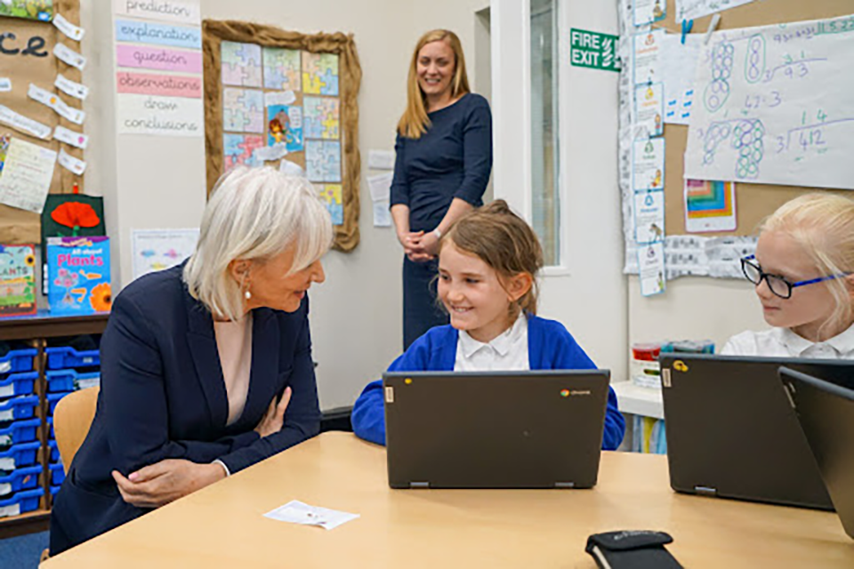 Secretary of State for the Department of Digital, Culture, Media and Sport Nadine Dorries talking to a student at Whitley Village School
