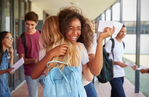 two girls celebrating GCSE exam results