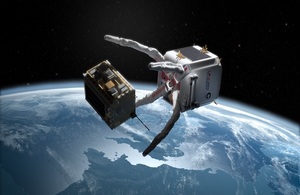 Artist's render of ClearSpace craft with UK Space Agency logo collecting debris in orbit.