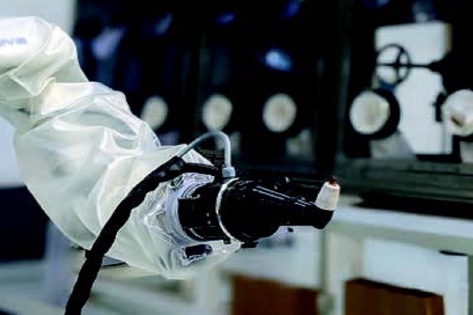 Robotic arm in containment sleeve with plasma cutter 