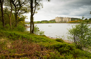View across a lake from the bank at the Trawsfynnydd nuclear power station