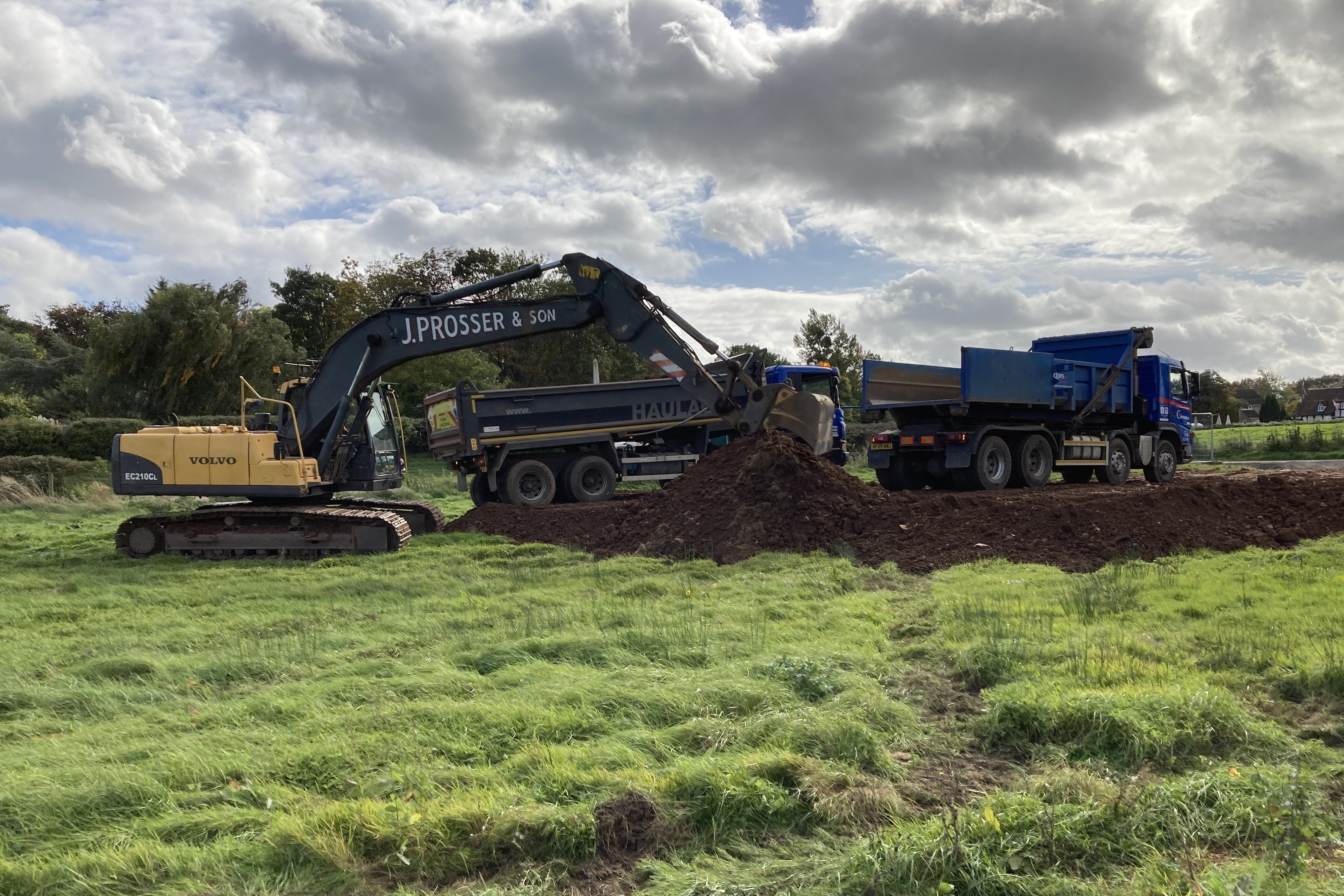 Large machinary delivering soil to site