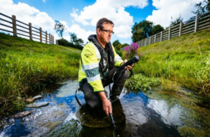 Image of Environment Agency employee monitoring water