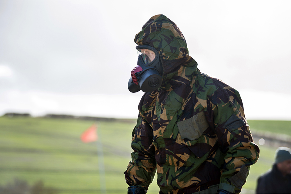 A scientist in camouflaged protective clothing 