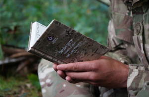 In close-up, the book is being read outside.