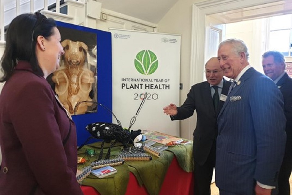 King Charles III viewing a plant health exhibit during the International Year of Plant Health.