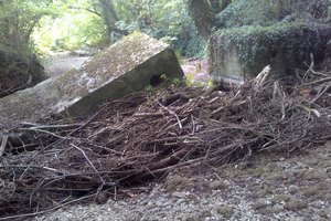 A large lump of concrete in the middle of a dried up watercourse