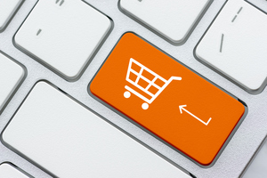White basket for checkout, shopping cart symbol on a laptop keyboard