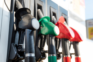 Four fuel pumps of different colours.