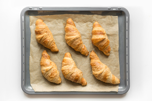 6 home-baked croissants on a tray