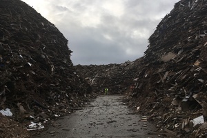 Photo shows waste site with pilled waste 