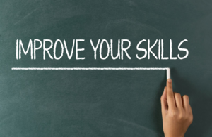 Improve your skills written on a blackboard with chalk