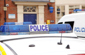 A police car outside a police station.