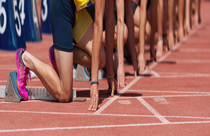 A photo of sprinters on a start line on an athletics track