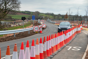 A car drives on the new road and bridge in the Lower Otter vally