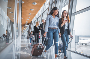 Young adults walking through airport