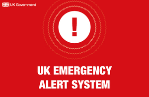 A red background with white text saying "UK Government" in the top left corner and in the centre of the image "UK Emergency Alert System"