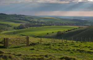 rolling hills with a gate and fencing