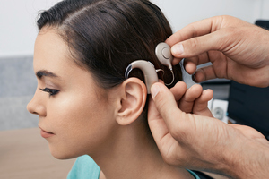 Young woman being fitted with a hearing implant