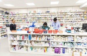 Pharmacists at work surrounded by many drugs