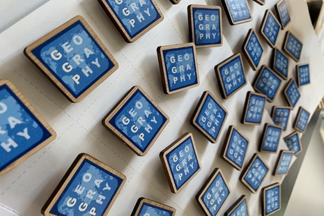 Government Geography Profession logos pinned on a wall