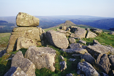 View of Dartmoor from the top of Leather Tor with stacked stones in the foreground