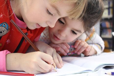 young children drawing together