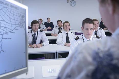Cadets pictured in a classroom looking at an instructor.