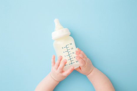 Baby holding bottle