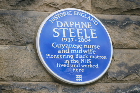 A round, blue plaque, which reads: Historic England; Daphne Steel 1927-2004; Guyanese nurse and midwife, pioneering Black matron in the NHS lived and worked here