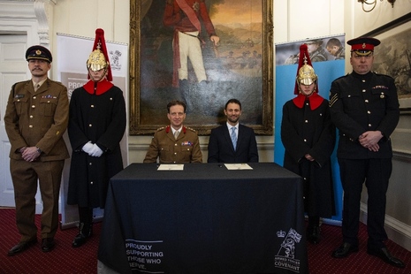 Colonel Chips Broughton MBE and Joe Kourea, Director of Operations at Lidl GB, surrounded by Horse Guards, marking a significant moment at the signing ceremony of the Armed Forces Covenant. Crown Copyright.