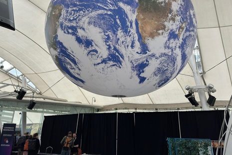 Large globe hanging over conference centre entrance hall.