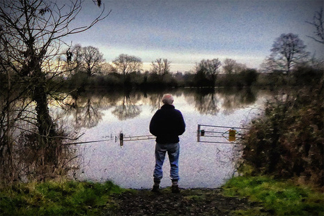 Person looking at a flooded river (Credit Mike Finn)
