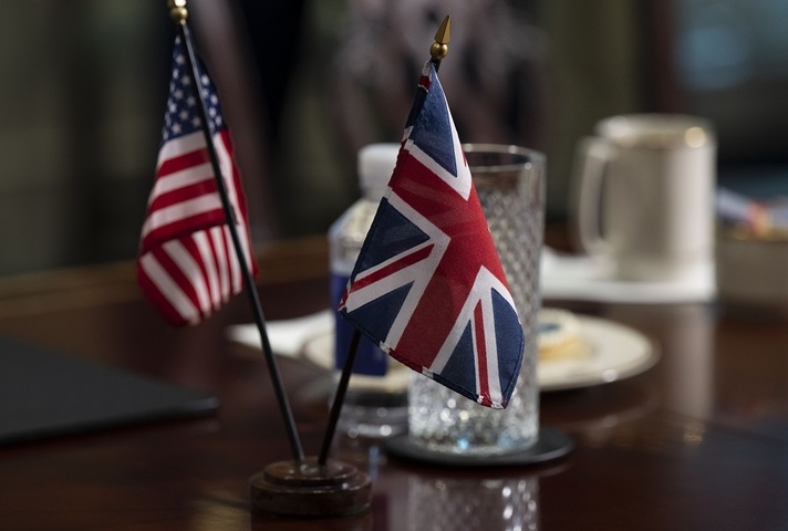 US and UK flags on a desk
