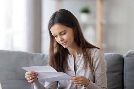A female student looking at a piece of paper