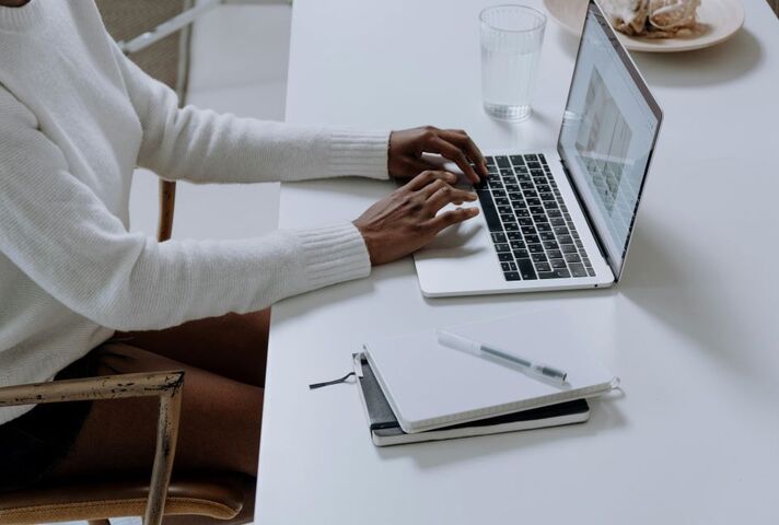 Image of person typing on a laptop