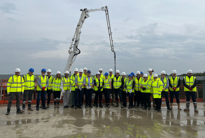 Representatives from the MOD, NHS, Tilbury Douglas and Aecom at the topping out ceremony. MOD Crown Copyright.