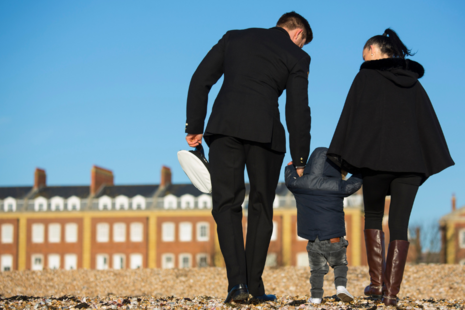 Royal Naval Physical Training instructor from the Royal Navy School of Physical Training (RNSPT) and his family walking on Portsmouth Beach. MOD Crown Copyright.